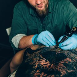 tattoo master makes a tattoo. Closeup. Selective focus